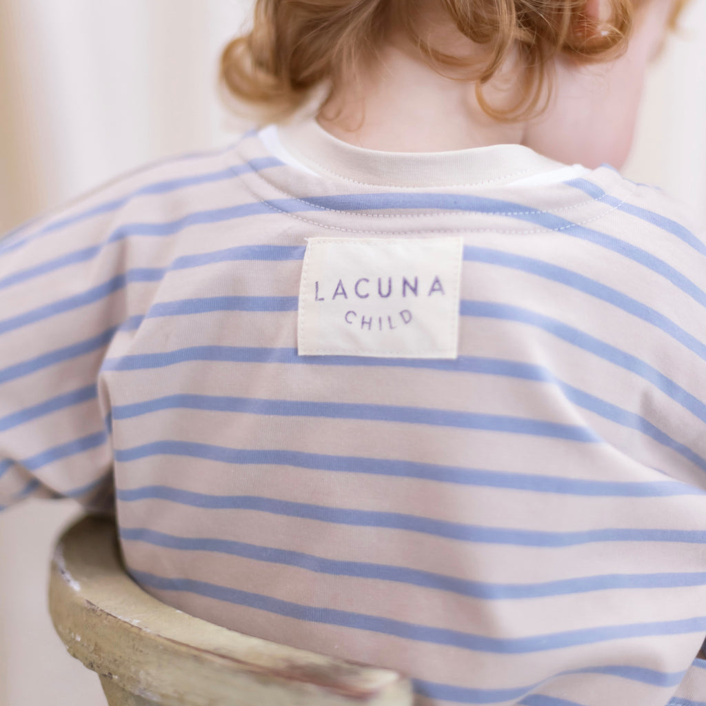 Back view of the blue/beige oversized kids oversized jersey top.  Showing the Lacuna Child branding label.