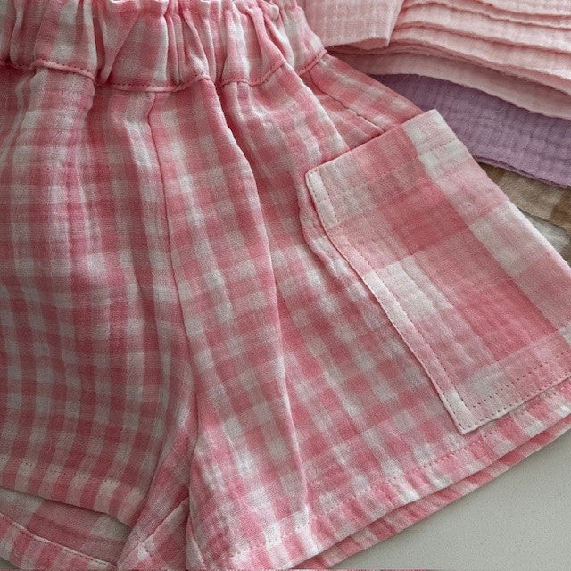 Pink gingham kids shorts with elasticated waist and oversized pocket